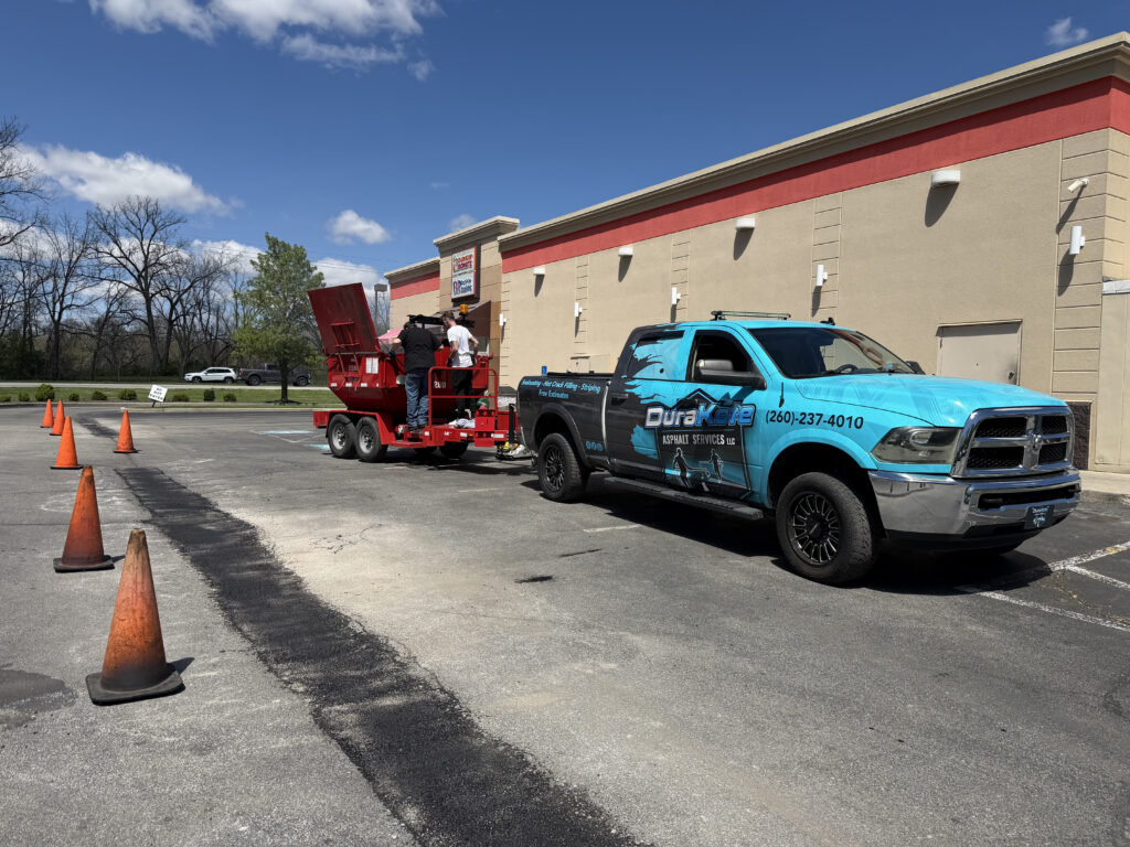 Picture of Durakote Asphalt Services Truck doing a road patching job.